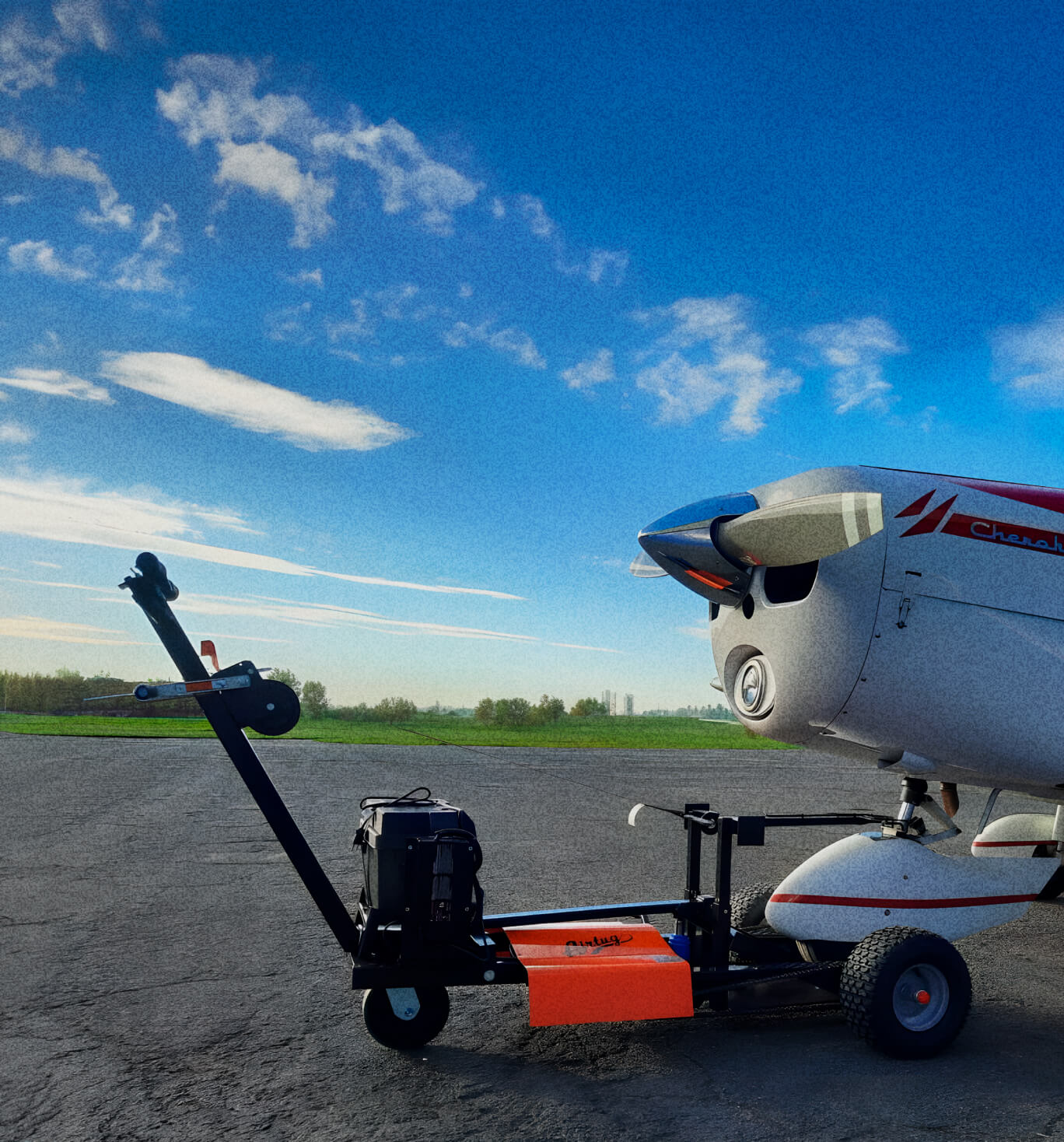 airtug pulling plane in front of a bright blue sky