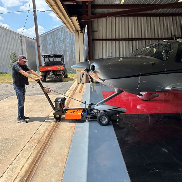 man pulling cirrus aircraft using an nfe tug from airtug