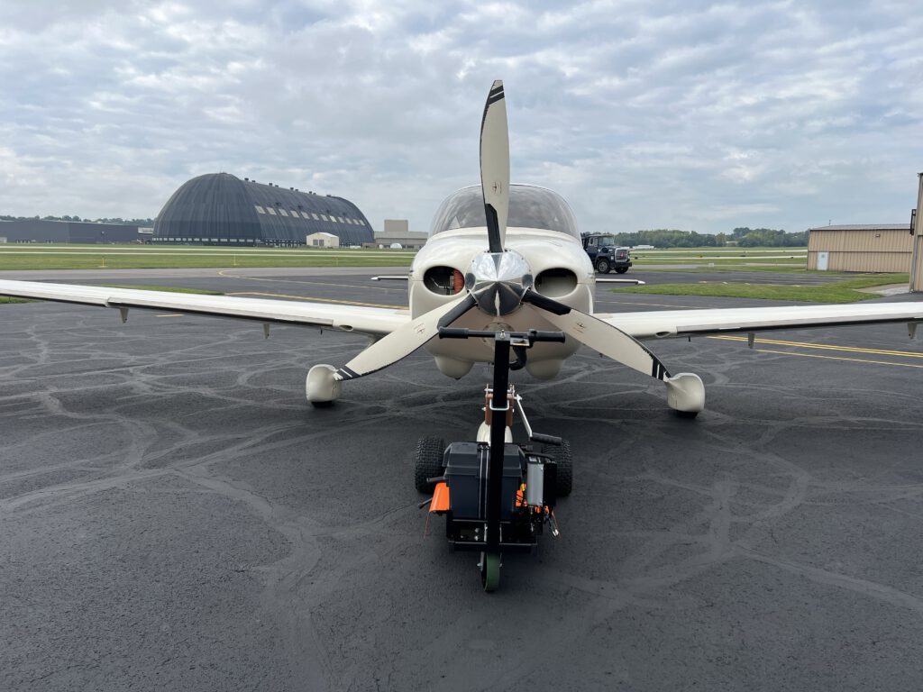 front view of a plane with aircraft tug attached