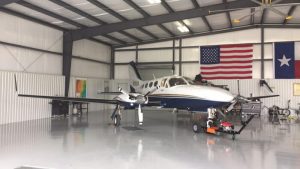 Chancellor plane parked in hanger with AIRTUG 6-S tug