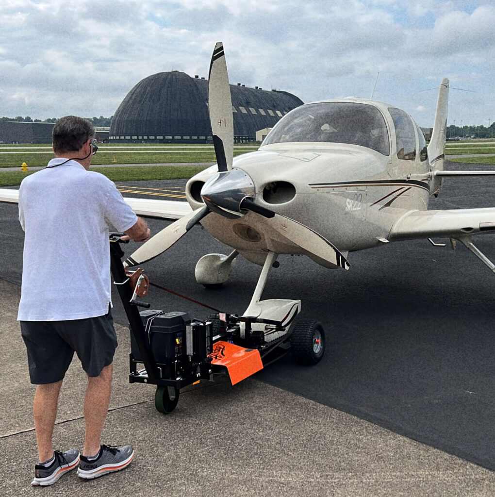 man moving a plane with aircraft tug