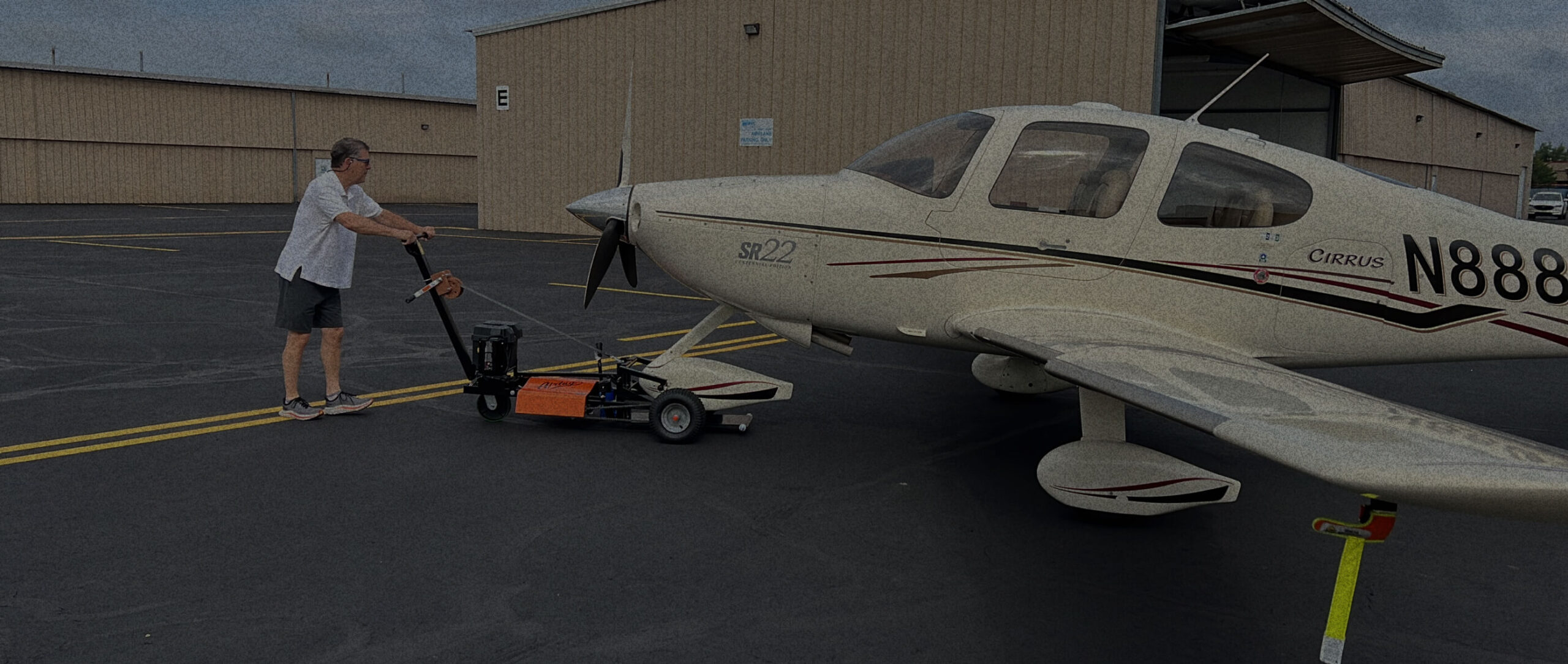 man pulling aircraft with an airtug plane tug