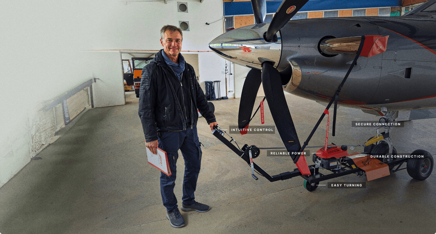 man standing by aircraft tug with labeling