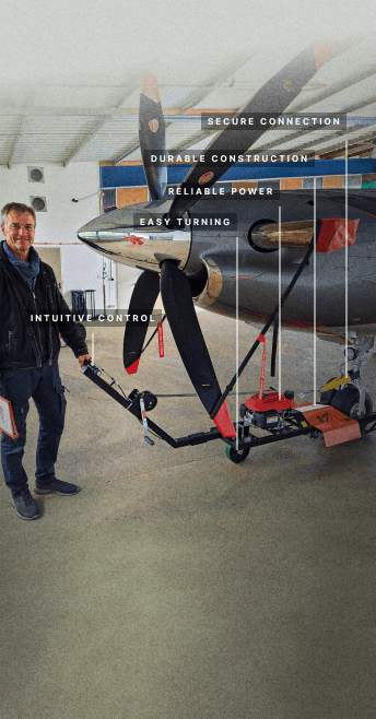 man standing by aircraft tug with labeling