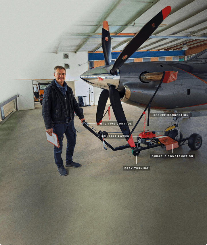 man standing by aircraft tug with labeling